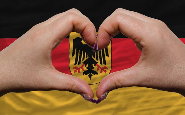 Over national flag of germany showed heart and love gesture made — Stock Photo, Image