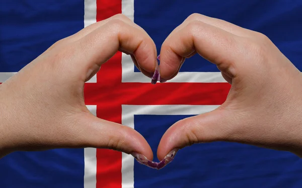 Over national flag of iceland showed heart and love gesture made — Stock Photo, Image