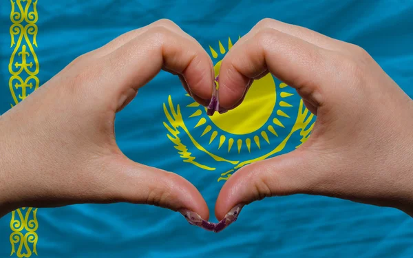 Over national flag of kazakhstan showed heart and love gesture m — Stock Photo, Image