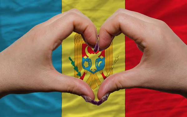 Over national flag of moldova showed heart and love gesture made — Stock Photo, Image