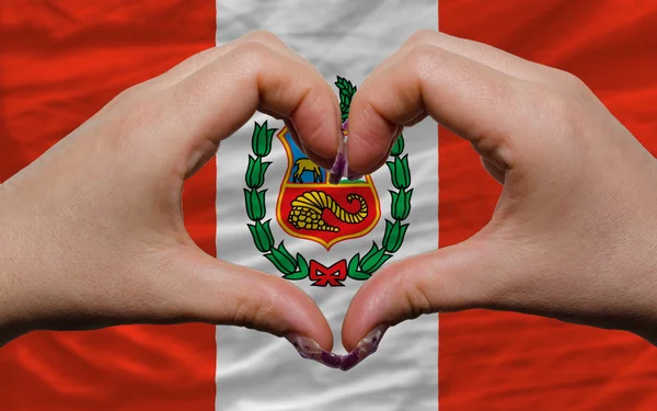 Over national flag of peru showed heart and love gesture made by — Stock Photo, Image