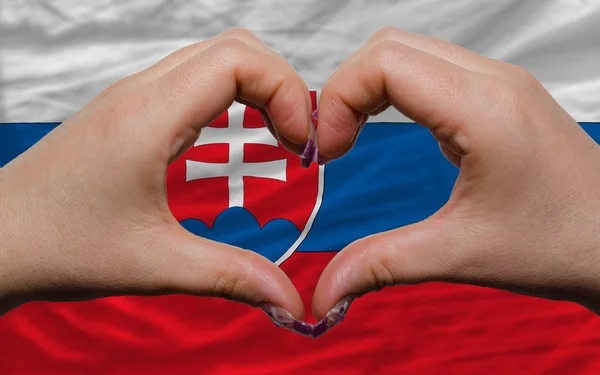 Over national flag of slovakia showed heart and love gesture mad — Stock Photo, Image