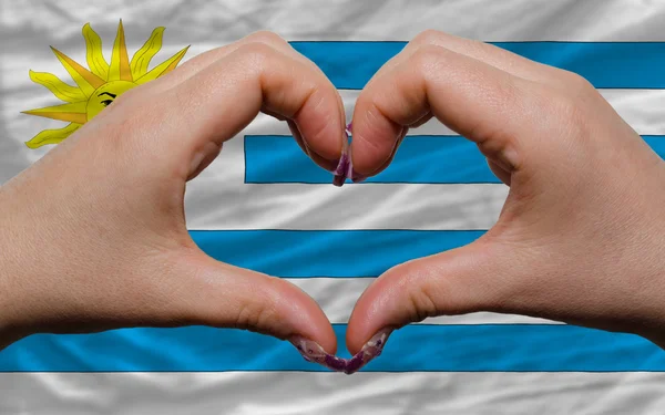 Över nationella flagga uruguay visade hjärta och kärlek gest gjort — Stockfoto