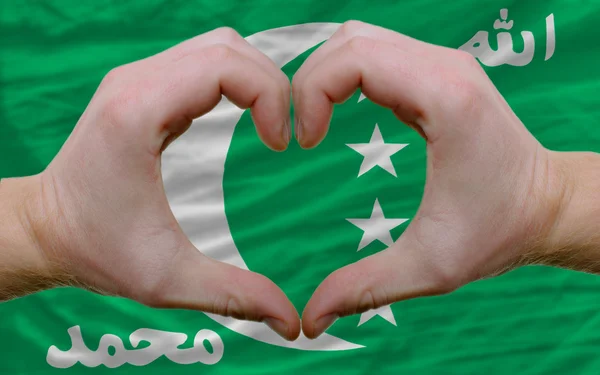 Over flag of comoros showed heart and love gesture made by hands — Stock Photo, Image