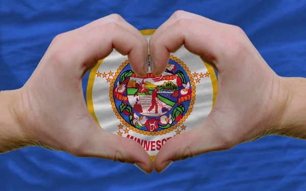 Over american state flag of minnesota showed heart and love gest — Stock Photo, Image