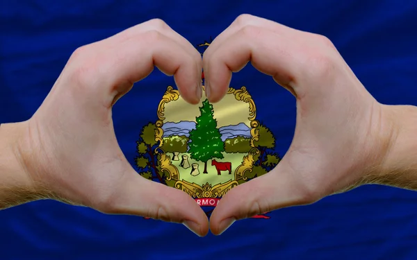 Over american state flag of vermont showed heart and love gestur — Stock Photo, Image