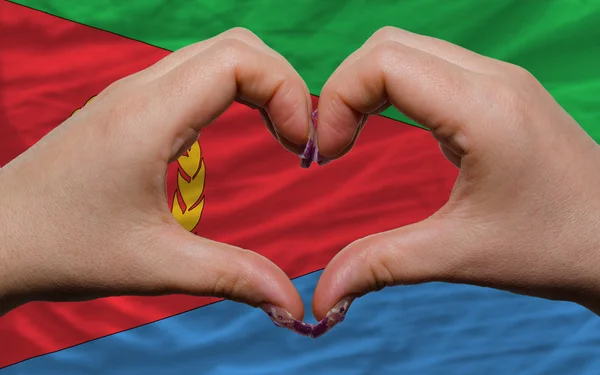 Over flag of eritrea showed heart and love gesture made by hands — Stock Photo, Image