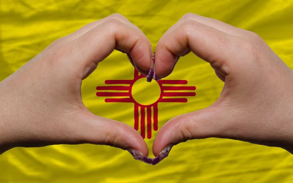 Over american state flag of new mexico showed heart and love ges — Stock Photo, Image