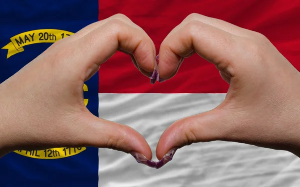 Over american state flag of north carolina showed heart and love — Stock Photo, Image