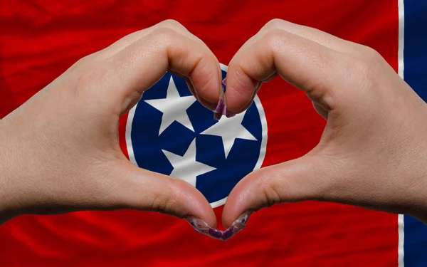 Over american state flag of tennessee showed heart and love gest — Stock Photo, Image
