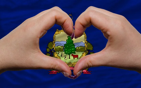 Over american state flag of vermont showed heart and love gestur — Stock Photo, Image