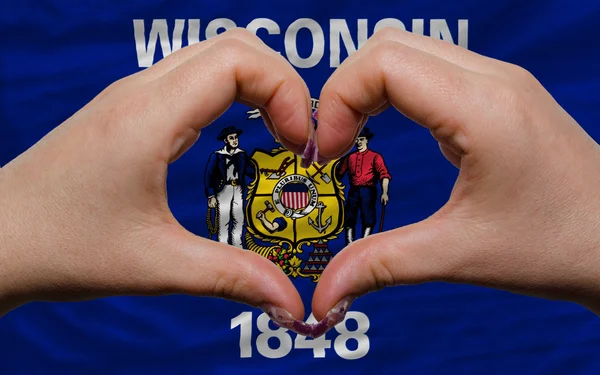 stock image Over american state flag of wisconsin showed heart and love gest