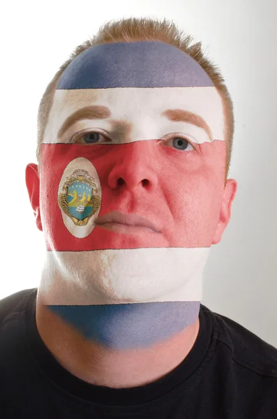 Face of serious patriot man painted in colors of costa rica flag — Stock Photo, Image