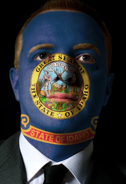 Bizi Idaho Eyalet bayrağı işadamı ya da politikacı yüzü boyalı — Stok fotoğraf