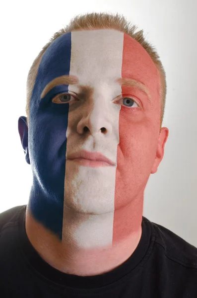 Face of serious patriot man painted in colors of france flag — Stock Photo, Image
