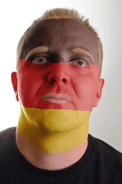 Face of serious patriot man painted in colors of germany flag — Stock Photo, Image