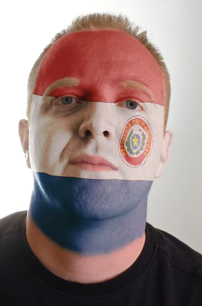 Face of serious patriot man painted in colors of paraguay flag — Stock Photo, Image