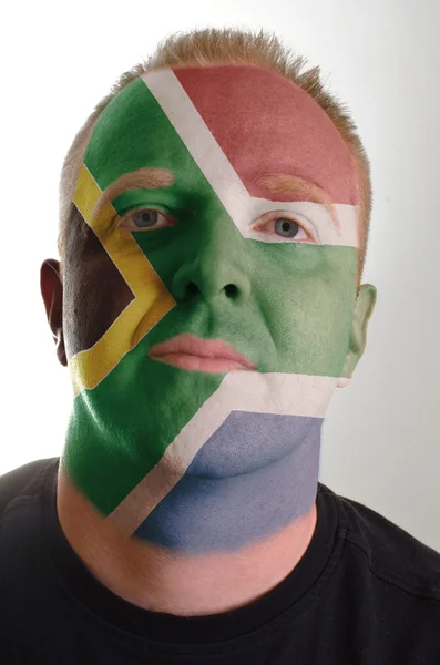 Face of serious patriot man painted in colors of south africa fl — Stock Photo, Image