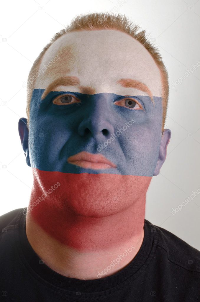 Face of serious patriot man painted in colors of russia flag