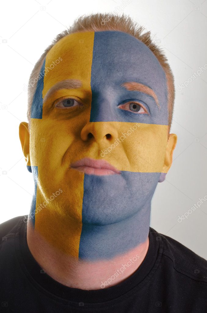 Face of serious patriot man painted in colors of sweden flag