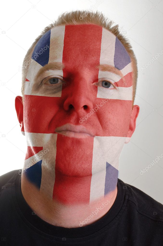 Face of serious patriot man painted in colors of united kingdom