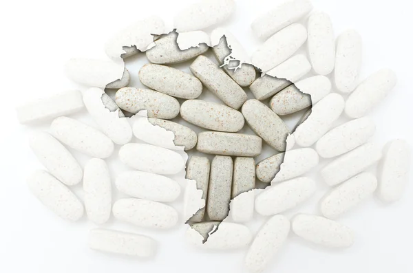 Outline map of brazil with pills in the background for health an — Stock Photo, Image