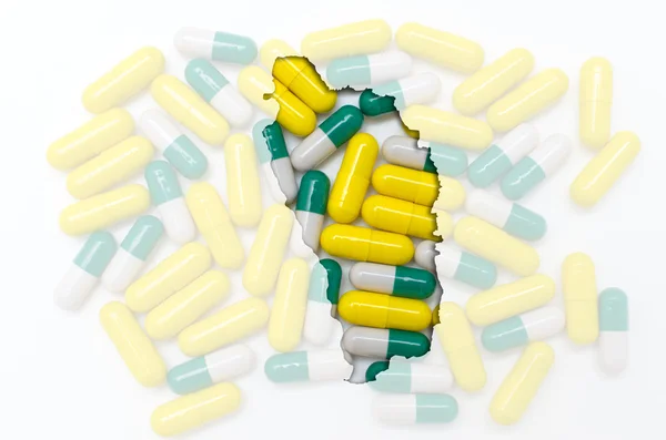 Konturkarta över dominica med piller i bakgrunden för hälsa — Stockfoto