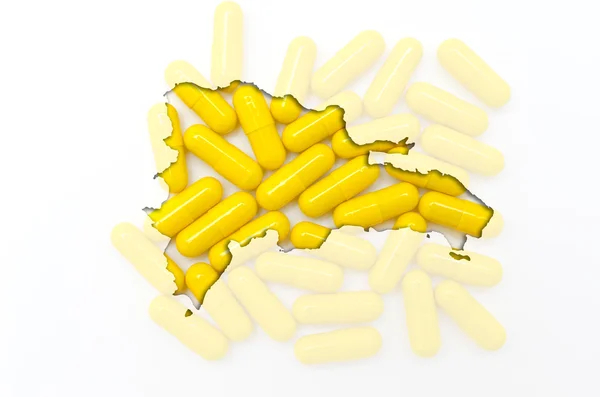 Outline map of dominican republic with pills in the background f — Stock Photo, Image