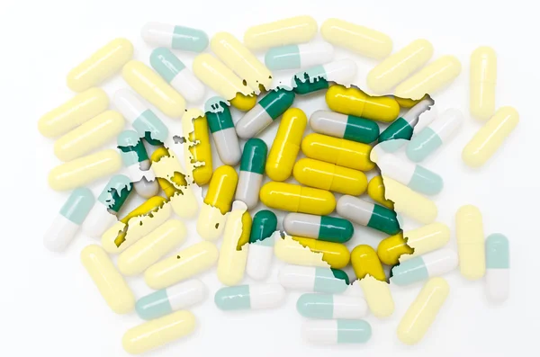 Konturkarta över Estland med piller i bakgrunden för hälsa en — Stockfoto