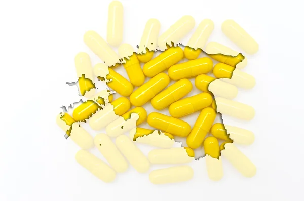 Outline map of estonia with pills in the background for health a — Stock Photo, Image