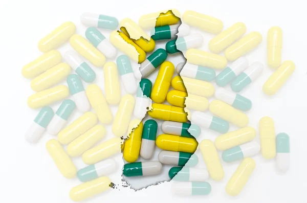 Konturkarta över finland med piller i bakgrunden för hälsa en — Stockfoto
