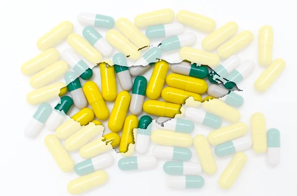 Контурна карта хінаруса з таблетками на задньому плані для здоров'я — стокове фото
