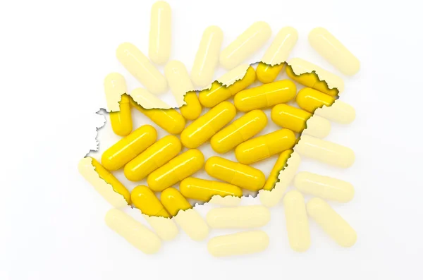Outline map of hungary with pills in the background for health a — Stock Photo, Image