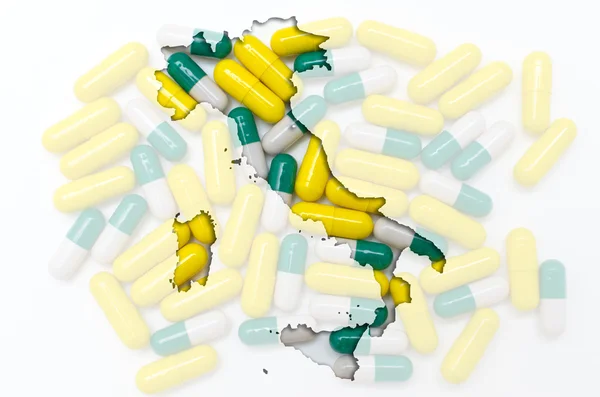 Outline map of italy with pills in the background for health and — Stock Photo, Image