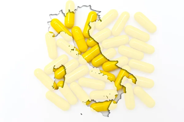 Outline map of italy with pills in the background for health and — Stock Photo, Image