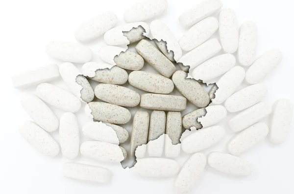 Outline map of kosovo with pills in the background for health an — Stock Photo, Image