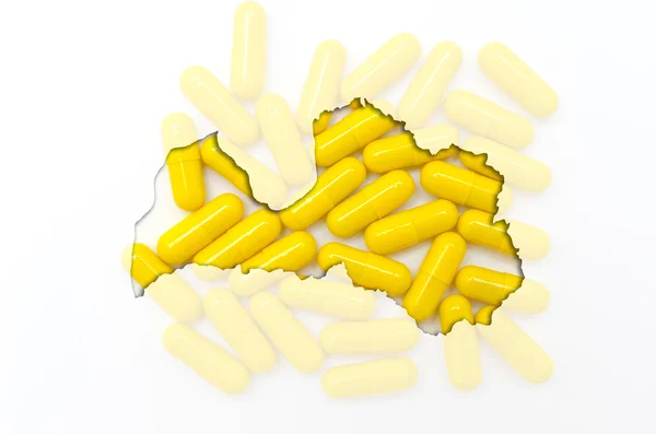 Outline map of latvia with pills in the background for health an — Stock Photo, Image
