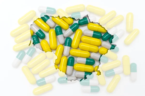 Outline map of lithuania with pills in the background for health — Stock Photo, Image