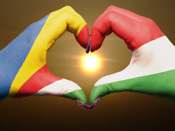 Heart and love gesture by hands colored in seychelles flag durin — Stock Photo, Image