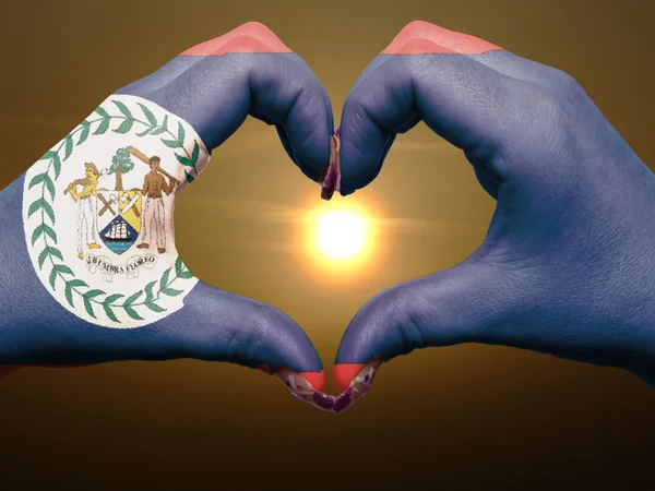 Cœur et geste d'amour par les mains colorées dans le drapeau du Belize pendant être — Photo