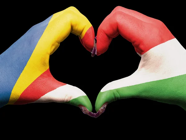 Heart and love gesture by hands colored in seychelles flag for t — Stock Photo, Image