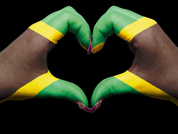 Corazón y gesto de amor con las manos coloreadas en la bandera de jamaica para la gira — Foto de Stock