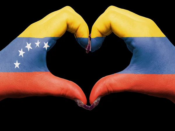 Corazón y gesto de amor con las manos coloreadas en la bandera de venezuela para t — Foto de Stock