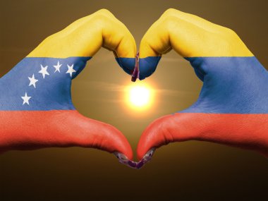 Heart and love gesture by hands colored in venezuela flag during clipart