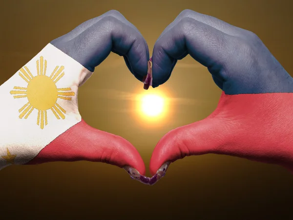 Heart and love gesture by hands colored in philippines flag duri — Stock Photo, Image