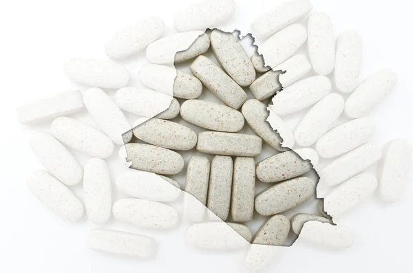Umrisskarte des Irak mit Pillen im Hintergrund für Gesundheit und — Stockfoto