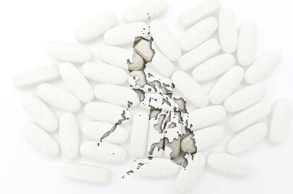 Konturkarta över Filippinerna med piller i bakgrunden för läka — Stockfoto
