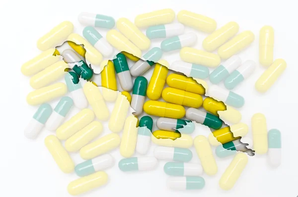 A tabletták, a háttérben a egészség körvonala Új-Guinea — Stock Fotó