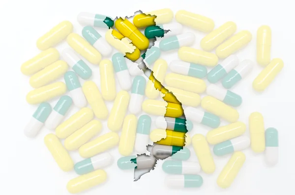 stock image Outline map of vietnam with pills in the background for health a