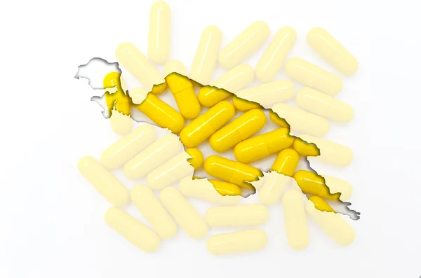 A tabletták, a háttérben a egészség körvonala Új-Guinea — Stock Fotó